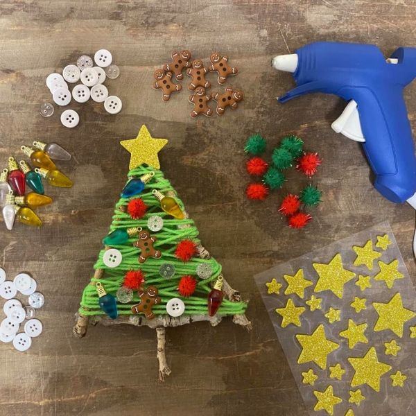 Adding decorations to stick Christmas tree