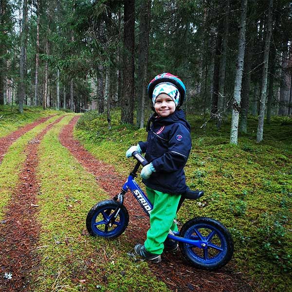 Riding a Strider bike in a forest