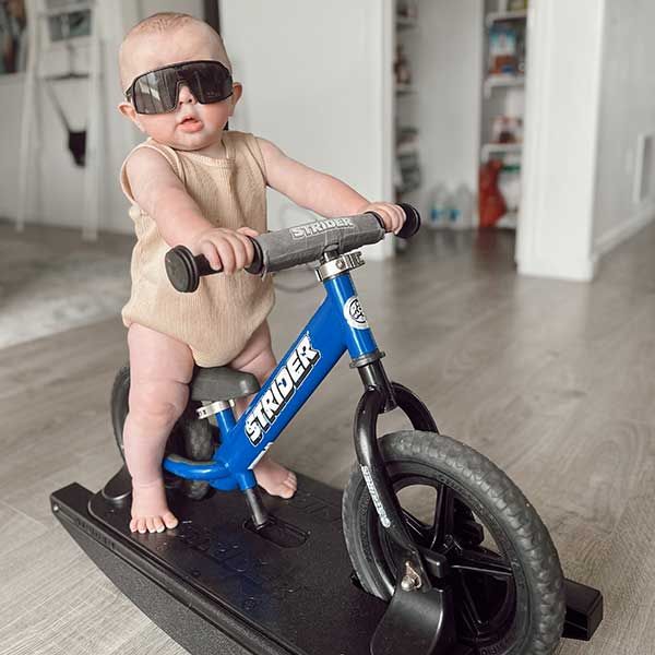 Cool baby in sunglasses on a Strider Rocking Bike
