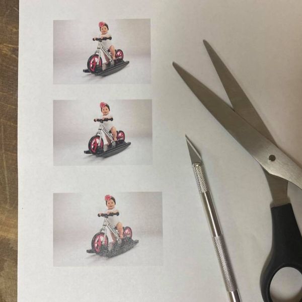 Cutting out a photo of a baby on a Rocking bike 