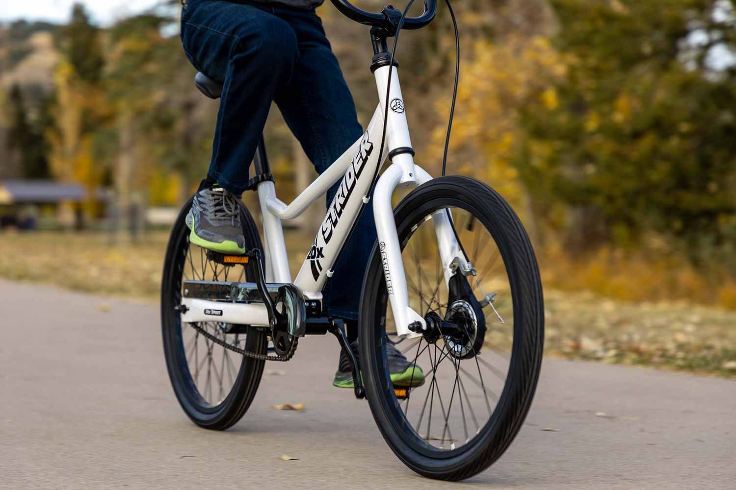 A rider pedaling the Strider 20x Sport, a 20" all-in-one balance and pedal bike