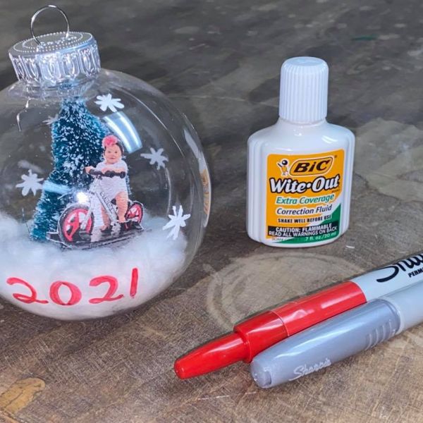 Decorating a glass ornament with Sharpies and Wite-Out 