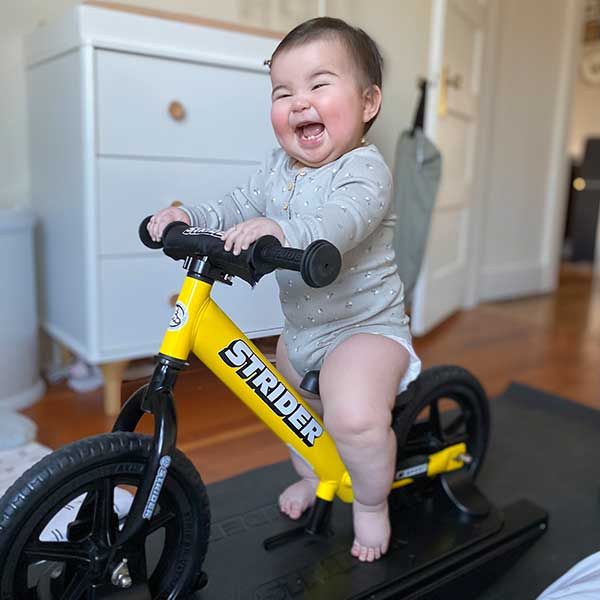 happy baby on a Strider Rocking Bike
