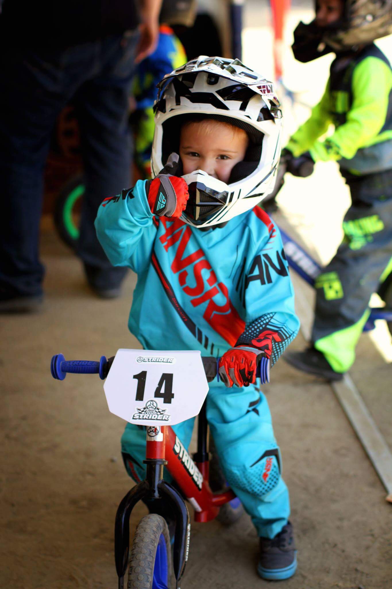 Kid giving thumbs up on custom 12 Sport with customized number plate