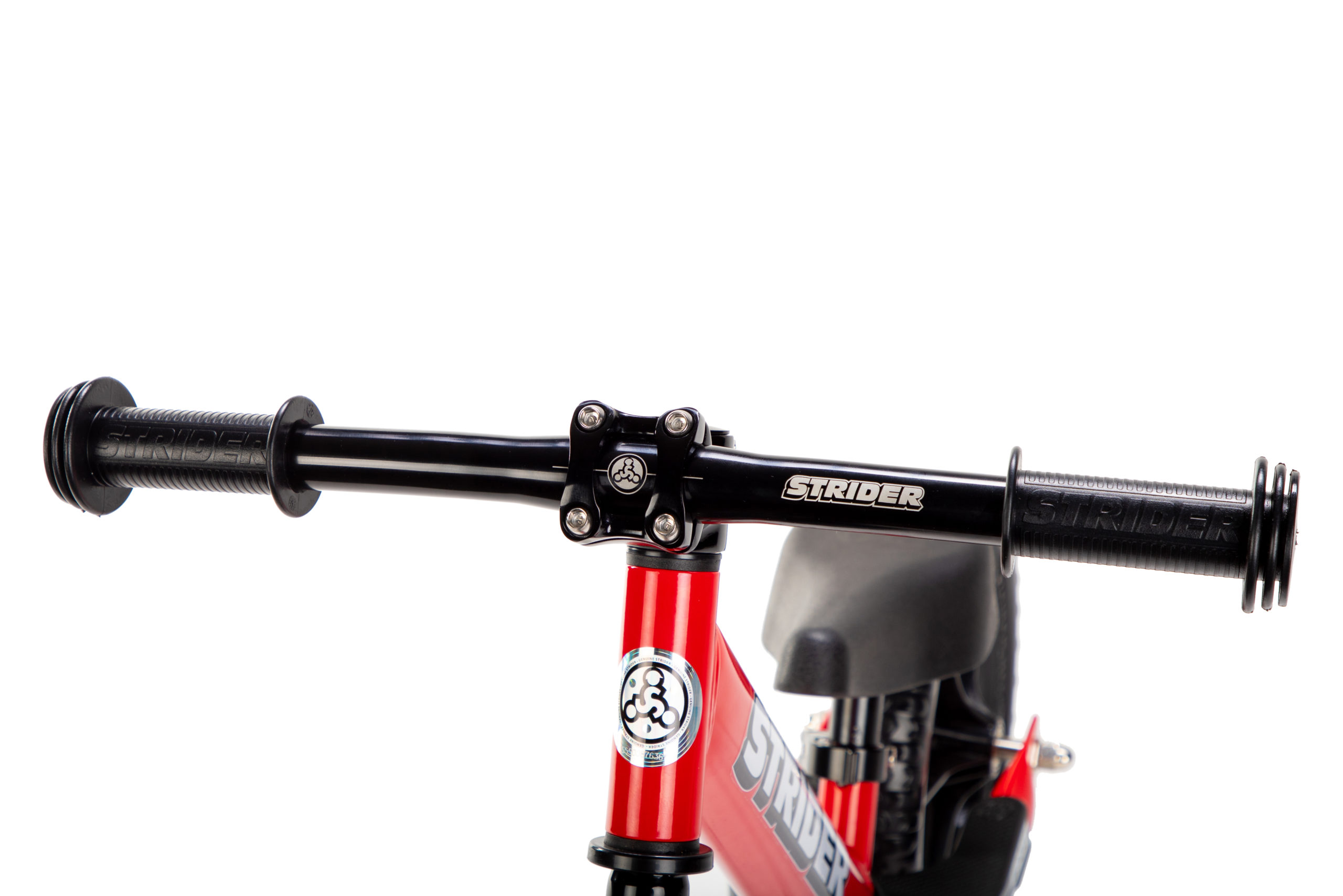 Studio image of Strider Aluminum Flat Handlebar with Grips on red 12 Sport - close-up angled view