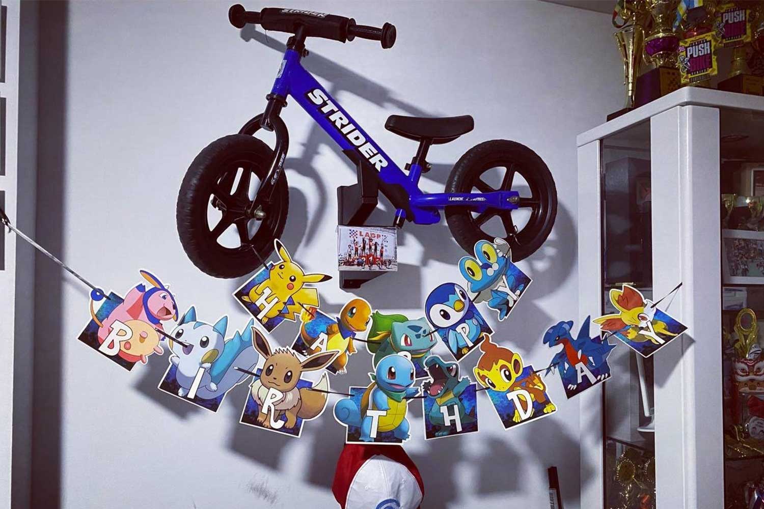 Strider Bike in a Memory Mount with a happy birthday banner below