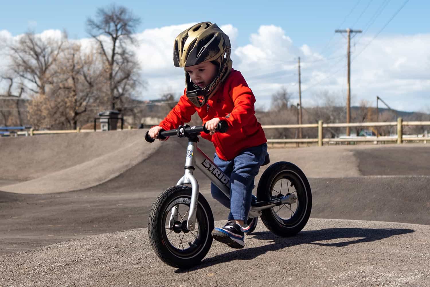 a rider in a skate park on a Strider 12 Pro balance bike with ST-R carbon wheels