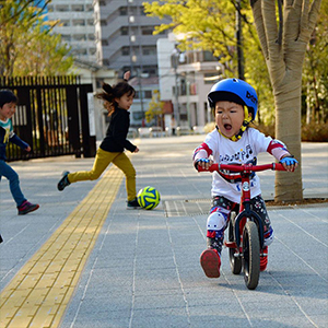 A child strides on their Strider Bike while looking rather angry