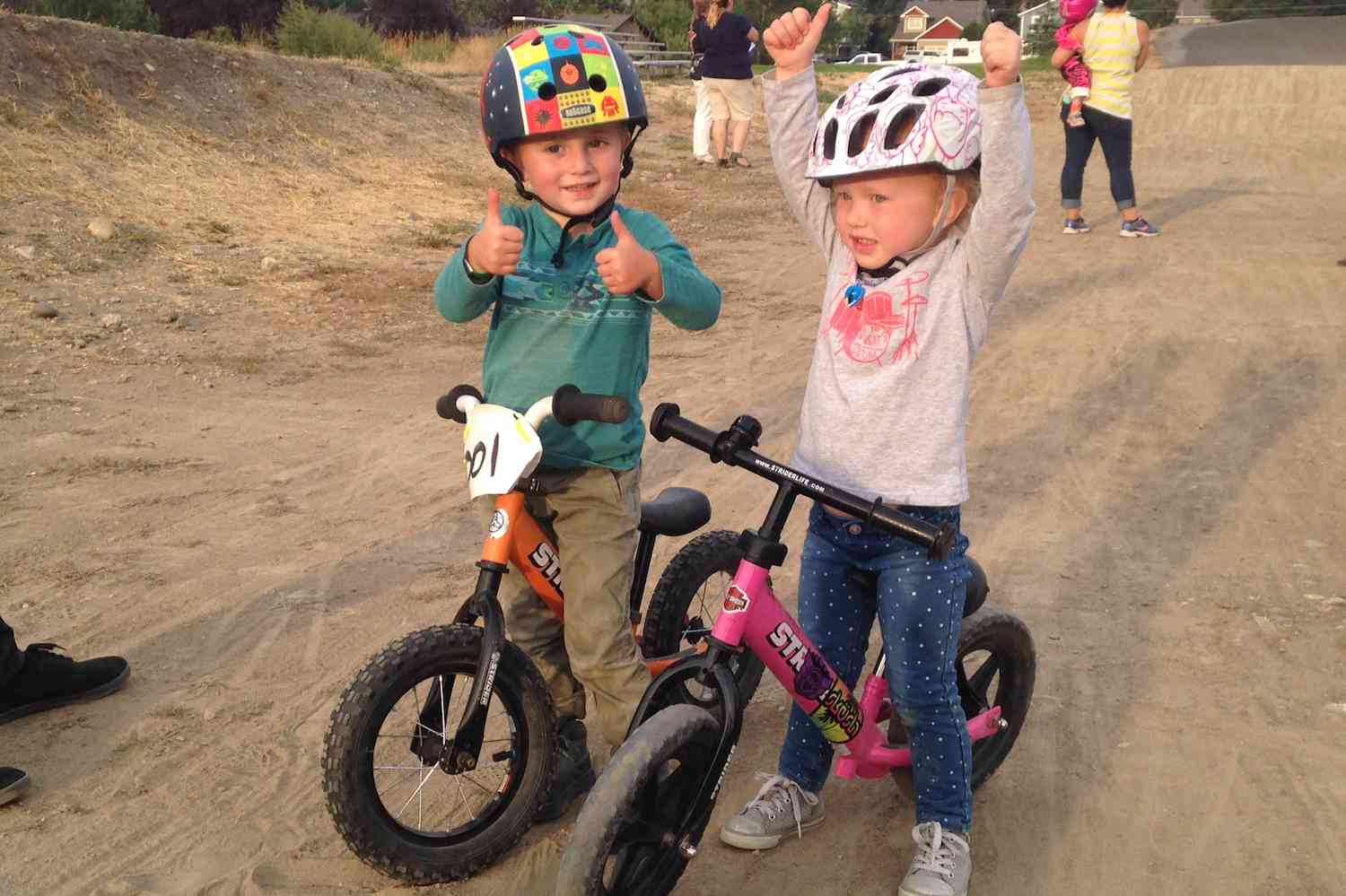 A boy and girl on 12" Strider balance bikes