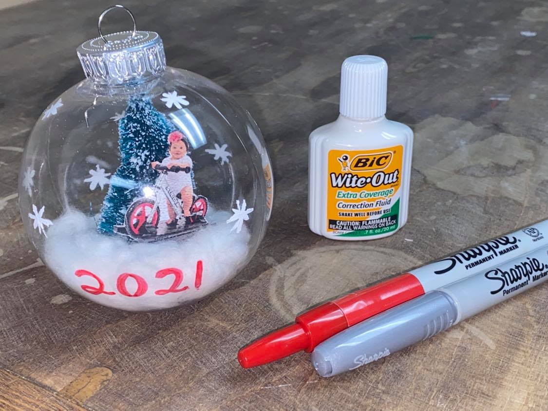 Decorating a glass ornament with Sharpies and Wite-Out 