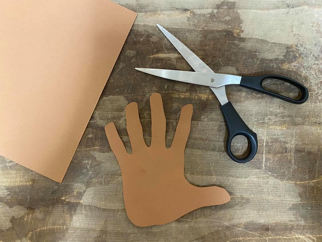 Tracing hand on brown construction paper