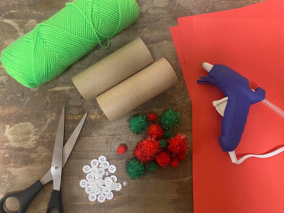 Craft supplies includes construction paper, scissors, yarn, glue, and toilet paper rolls