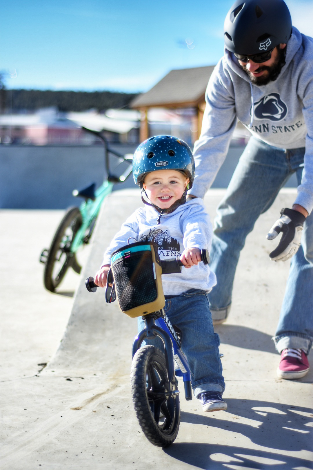 Child rides Blue Strider Balance Bike at skatepark