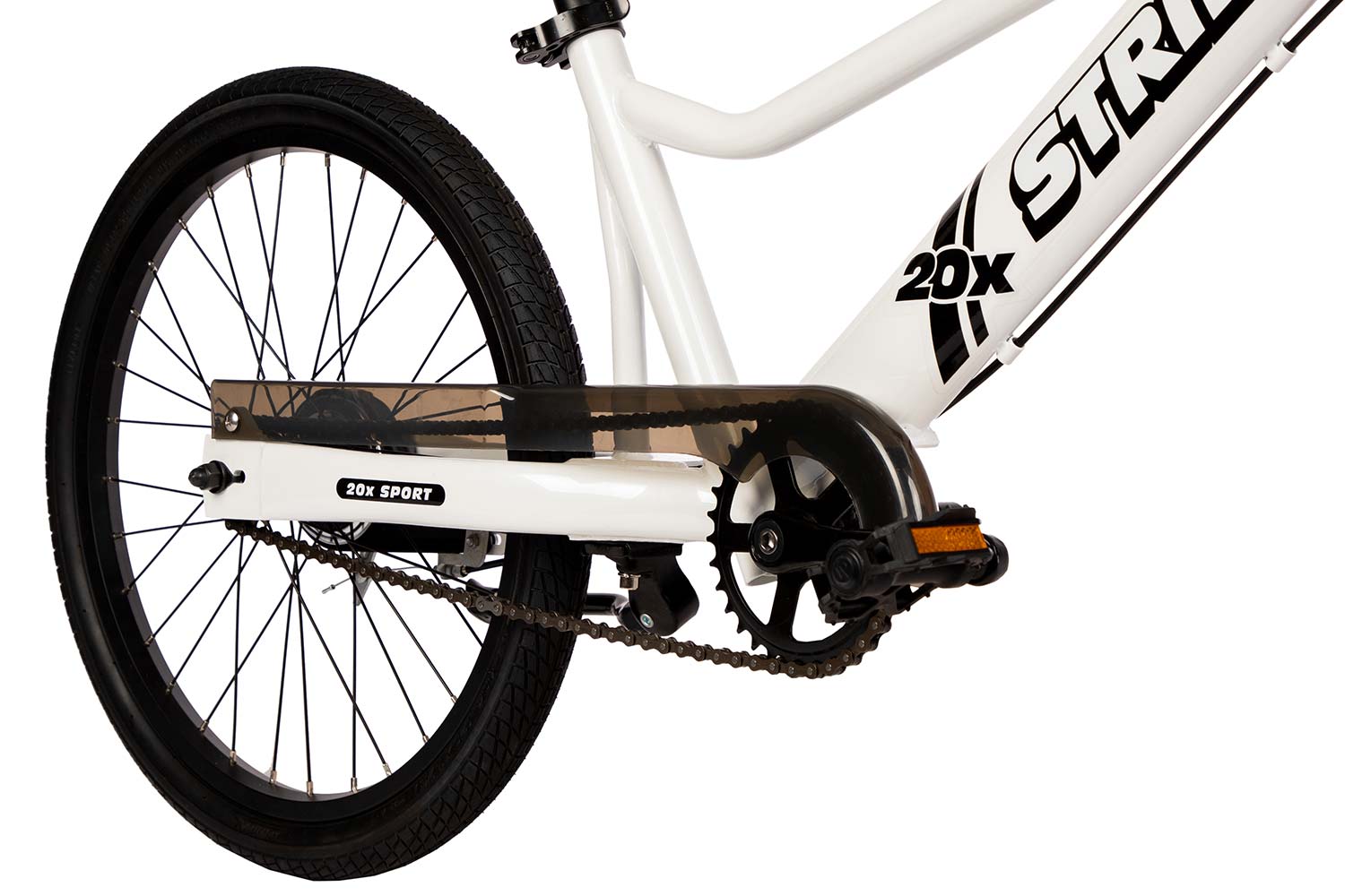 A studio detail of the pedals and chainguard on the Strider 20x Sport, a 20" all-in-one balance and pedal bike
