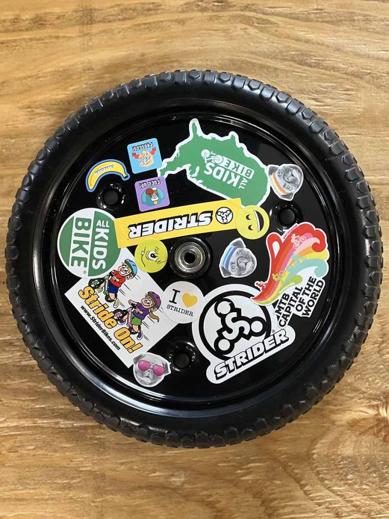 Strider Disc Wheel Cover decorated with stickers